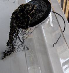 This Black and Gold Beaded Flower Sinamay Fascinator Hat with Veil and Satin Headband is a beautiful accessory for weddings, parties, cocktail, evening, and other special occasions. It is elegant, sparkling, stylish, and super chic! The perfect Fall/Winter piece that will definitely add a special touch to your outfit!! ** Black Sinamay Base is 10 cm. I only accept PayPal and ship all orders within 24 hours via USPS. Feel free to send me a convo with any questions. Thank you for visiting Hettie Hair Accessories! Adjustable Gatsby Evening Headpiece, Adjustable Gatsby Style Costume Hats For Evening, Adjustable Gatsby Style Evening Costume Hat, Adjustable Beaded Headband For Party, Gatsby Style Evening Fascinator Headband, Gatsby Style Headband Hat For Evening, Evening Gatsby Style Fascinator Headband, Gatsby Style Evening Fascinator For Kentucky Derby, Elegant Handmade Headpiece With Structured Crown