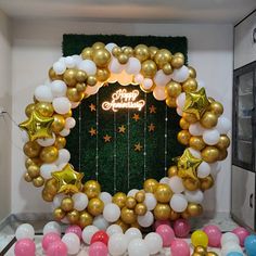 balloons and streamers are arranged around a happy new year's wreath on display