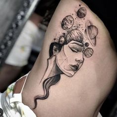 a woman's face with planets and stars on her thigh