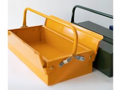 two yellow and green boxes sitting next to each other on a white surface with handles