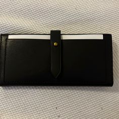 Brand New, Never Used Wallet With Protective Wrapping Black Leather Bifold Clutch, Black Travel Wallets With Snap Closure, Black Rectangular Wallet With Snap Closure, Black Travel Wallet With Snap Closure, Black Wallet With Snap Closure, Chic Black Bifold Coin Purse, Black Wallet With Magnetic Closure For Daily Use, Black Leather Clutch With Rfid Blocking, Classic Black Clutch With Card Slots