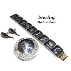 *Description: This is a sterling silver bracelet, brooch, and screwback earrings with black enamel from the 1930s.  Siam's name was officially changed to Thailand in 1939.  These pieces have never been worn but have natural patina on the silver. This would be a great addition to your vintage jewelry collection or make a great vintage gift! *Reference: Brief history of the designs: It is technically Niello or Nielloware, created by carving out areas of the silver, and baking a sulfur/metals powde Victorian Enamel Jewelry For Formal Occasions, Traditional Hallmarked Jewelry For Evening, Victorian Enamel Jewelry For Formal Events, Victorian Formal Enamel Jewelry, Classic Engraved Enamel Jewelry, Sterling Silver Art Deco Jewelry With Polished Finish, Vintage Sterling Silver Hallmarked Jewelry, Art Deco Sterling Silver Jewelry With Polished Finish, Antique Jewelry With Screw Back For Gift