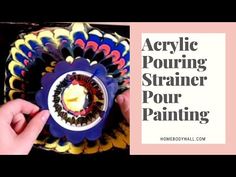 a person is holding a colorful object with the words acrylic pouring strainer pour painting