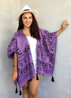 "This boho kimono jacket is made of cotton fabric. It has black tassels at the hemline. Designed with an open front, extra loose, plus size, and wide arm openings that create 3/4 length sleeves when you have it on. This tribal kimono cardigan comes in a wide and loose style, one size fits all. It adapts to different body types. The Nordic patterned purple fabric is very unique. You can use this purple poncho with jeans or shorts at Music Festivals. Also, it can wear as a beach cover-up on your s Summer Cotton Fringe Outerwear, Bohemian Cotton Outerwear With Tassels, Bohemian Summer Outerwear With Tassels, Black Cotton Kimono For Festivals, Bohemian Cotton Outerwear For Vacation, Bohemian Cotton Beach Outerwear, Bohemian One-size Cotton Outerwear, Summer Festival Cotton Outerwear, Bohemian Cotton Kimono For Festival