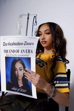 a woman sitting in a chair holding up a newspaper with an image of her on it