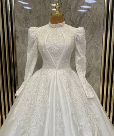 Majestic High-Neck Beaded Satin Ball Gown with Sculpted Long Sleeves and Intricate Appliqué Wedding Dresses With Sleeves Ball Gown, Quince Planning, Full Sleeve Gowns, Outfit Ideas College, Extravagant Wedding Dresses, Ballroom Gowns, Voluminous Skirt, Satin Ball Gown, High Neck Wedding Dress