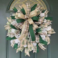 a green and white wreath on the front door