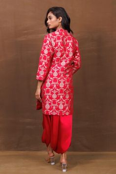 Red kurta featuring a handwoven banarasi silk fabric with an all-over contrast metallic floral jaal pattern and mandarin collar. Paired with a pleated cowl draped dhoti pant., Fit: Relaxed Red Tilla Sharara, Festive Red Sets With Tilla Details, Palazzo Set For Puja, Red Sets With Tilla In Traditional Drape, Red Sets With Tilla Detail And Traditional Drape, Festive Red Tilla Sets, Festive Red Traditional Wear With Tilla, Fitted Churidar For Festive Occasions, Traditional Drape Palazzo Set For Diwali Puja