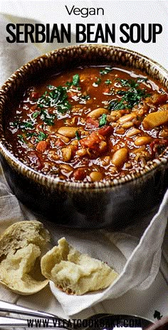 a bowl filled with beans and tortilla chips on top of a white table