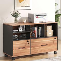 a computer desk with two drawers and a printer on the top shelf next to it