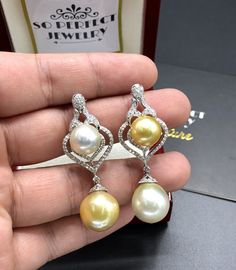 We are presenting you a HUGE pair of CHANDELIER, Genuine, Golden & White South Sea Pearls, extremely FINE A+, LUSTROUS and Rare! Accenting the 4 pearls are 110 pieces of F/VS Natural diamonds, weighting a total of 1.30 carats. Set in fabulously designed 18K solid white gold, chandelier earrings ONLY ONE ITEM AVAILABLE!! NO DUPLICATES!! WHAT YOU SEE IN THE PICTURES IS WHAT YOU WILL GET SOLIDLY HANDCRAFTED EARRINGS! SUGGESTED RETAIL VALUE: $8,500 PEARLS: Size: Bottom 14 x 15 mm, top 12 mm roun Luxury Yellow Gold Drop Pearl Earrings, Luxury Yellow Teardrop Earrings, Luxury White Gold Drop Pearl Earrings, Luxury Yellow Dangle Earrings, Luxury White Dangle Bridal Earrings, Luxury White Drop Earrings, Elegant White Pear Shaped Earrings, Luxury White Drop Bridal Earrings, White Drop Luxury Jewelry