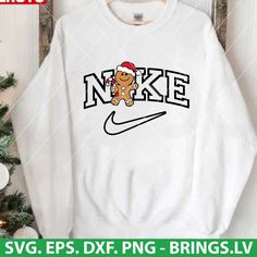 a white sweatshirt with the word nike on it and a cartoon dog wearing a santa hat