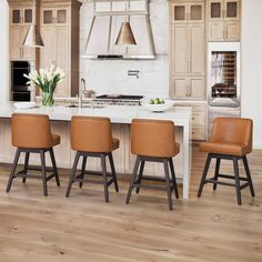 a kitchen with white marble counter tops and brown leather stools next to an island