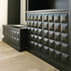 a large black cabinet sitting next to a window