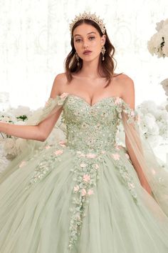 Get ready to be the belle of the ball in this enchanting Sage Quinceanera ball gown! This gorgeous gown is perfect for any young girl celebrating her special day in classic style. Its strapless bodice has been adorned with stunning floral and lace applique that make this dress utterly captivating. The blush pink floral accents give it a dreamy, feminine look that's sure to dazzle any crowd, while its off-the-shoulder tulle sleeves add an extra touch of romance. And with its elegant lace up corse Sage Quinceanera, Robes Quinceanera, Floral Ball Gown, Cape Sleeve Dress, Cinderella Divine, Tulle Sleeves, Dresses Quinceanera, Quinceanera Dress, Corset Back