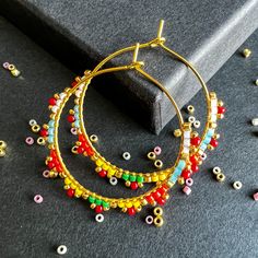 Color : Gold or silver with opaque white, opaque turquoise, opaque orange, opaque yellow, Opaque Kelly green with red seed bead You can choose between Gold/Silver plated hoops. The hoop size is 30mm. Earring Length 4cm, Width 3 cm. These earrings epitomize craftsmanship, utilizing top-tier branded beads such as Miyuki Delica beads and TOHO seed beads. Meticulously handcrafted with a robust beading thread, these earrings guarantee enduring shape retention and bead stability, even with continuous wear. A diverse spectrum of color combinations is available to cater to individual preferences, while all metallic components are expertly fashioned from high-quality brass. Hypoallergenic earring hooks prioritize wearer comfort and safety. Each design in the shop reflects a profound commitment to a Gift Dangle Hoop Earrings With Spacer Beads, Small Hoop Beaded Earrings With Spacer Beads For Gifts, Small Hoop Beaded Earrings With Spacer Beads As Gift, Multicolor Tiny Beads 14k Gold Filled Jewelry, 14k Gold Filled Multicolor Tiny Beads Jewelry, Multicolor Small Hoop Jewelry With Spacer Beads, Multicolor Hoop Jewelry With Spacer Beads, Minimalist Earrings With Dangling Beads As Gift, Handmade Multicolor 14k Gold Filled Jewelry