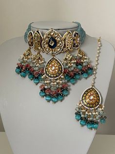 Please visit our website: www.sakavanojewellery.com for all our discounts and offers.  A Stunning Statement bridal/ semi bridal Meenakari Kundan  choker set with gorgeous earrings and tikka (headpiece) This set comes with gorgeous statement blue drops with a hint of peach beads.  This set is absolutely gorgeous and a one off piece ideal for all occasions.   Please note we do not offer any refunds or exchanges due to hygiene reasons. Blue Bollywood Meenakari Sets, Blue Chandbali Bridal Necklace For Diwali, Festive Blue Kundan Bridal Necklace, Blue Bollywood Bridal Necklace For Festivals, Festive Blue Kundan Necklace With Cutdana, Blue Tilla Bridal Necklace For Diwali, Blue Bridal Necklace With Stone Work For Festivals, Blue Meenakari Bridal Necklace For Wedding, Blue Cutdana Chandbali Jewelry