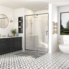 a large bathroom with black and white tiles on the floor