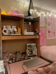 a desk with a laptop computer on top of it next to a shelf filled with items