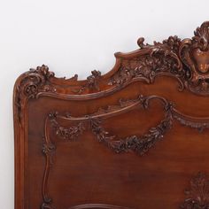 an ornate wooden bed frame with carved details