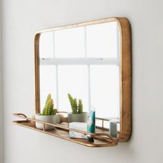 a bathroom mirror sitting on top of a shelf