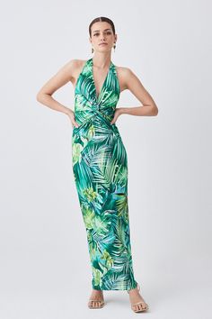 {@@=Ist.Core.Helpers.StringHelper.ToProperCase("A quintessential summer piece, this maxi dress exudes a playful-yet-elegant aesthetic. This piece is enriched with vibrant hues and a palm print. A ruched waist creates a flattering effect, style this piece with sandals or heels for a holiday-ready ensemble.Palm printRuched fabricMaxi hemlineHalter necklineSleeveless designExpertly designed for those 5'3" and under, our Petite pieces are perfectly proportioned for a smaller frame using shorter leng Beachwear Halter Neck Ruched Dress, Ruched Halter Neck Beach Dress, Ruched Dress For Beach Party Season, Ruched Dress For Beach Party, Beachwear Maxi Dress With Ruched Details, Summer Ruched Maxi Dress, Spring Tropical Maxi Dress, Beachwear Maxi Dress For Summer Parties, Chic Ruched Maxi Dress For Vacation