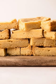 a stack of shortbreads sitting on top of a wooden cutting board