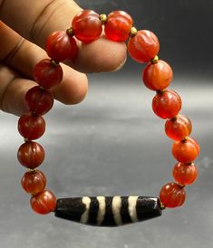 Genuine Tibetan dzi 4 stripe bead with carved carnelian bead bracelet handmade Beaded Round Carnelian Bracelets, Unique Handmade Carnelian Beads, Beaded Round Carnelian Bracelet, Carnelian Round Beads, Artisan Hand-strung Carnelian Beads, Carnelian Beads, Beaded Animals, Coral Beads, Bracelets Handmade Beaded