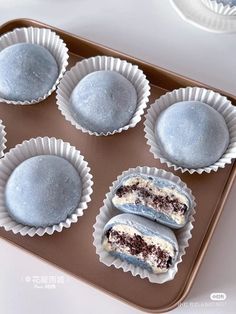 six blue desserts sitting on top of a cookie sheet