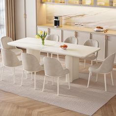 a dining room table with white chairs around it