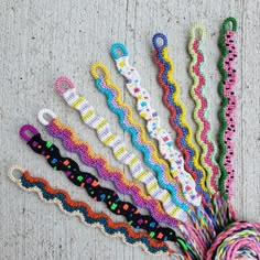 there are many different colored crochet ties on the floor