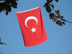 a turkish flag is flying in the sky