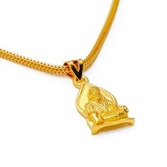 This attractive pendant, exquisitely crafted from 22k gold and weighing 3.2 grams, features a finely engraved depiction of Sai Baba set against a luminous yellow gold finish. The pendant has a length of 0.9 inches, making it both noticeable and modest in size, ideal for daily wear. Perfect for devotees who wish to keep Sai Baba close to their hearts, this pendant combines spiritual devotion with elegant craftsmanship, offering a timeless piece that embodies grace and serenity. PRODUCT DETAILS Gold Purity(karat): 22k Gold Weight(grams): 3.2 Item Finish: Yellow Gold Pendant Length: 0.9" Chain: Not Included Traditional Medallion Necklace With Polished Finish, 22k Gold Amulet Locket Jewelry, 22k Gold Necklaces For Puja, Gold Necklace With Large Pendant For Festivals, Yellow Gold Amulet Necklace For Rituals, Gold Necklaces With Large Pendant For Festivals, Spiritual Engraved Necklace For Puja, 22k Gold Locket Temple Necklace, 22k Gold Locket Necklace In Temple Jewelry Style