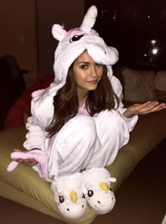 a woman in a bunny costume sitting on a couch with two stuffed animals around her