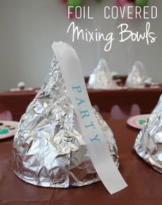 foil covered mixing bowls are sitting on a table