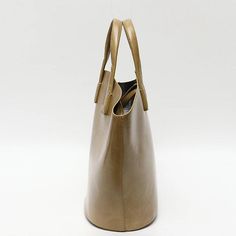 Discover Everyday Elegance Step into the world of sophistication with our Elegant Vegan Leather Tote Bag, a perfect blend of style and functionality. Crafted for the modern woman, this bag is not just an accessory; it's a statement. Whether you're heading to work, a casual outing, or a special event, this tote bag will elevate your style with its simple yet chic design. Product Features Our tote bag stands out with its unique bucket shape, offering a fresh take on the classic tote design. The blend of short handles and long straps provides versatile carrying options, catering to your comfort and preference. Made from high-quality vegan leather, this bag not only looks luxurious but also aligns with ethical fashion choices. The open closure with a secure zip liner bag ensures your belonging Chic Satchel Bag For On-the-go, Classic Bucket Shoulder Bag For On-the-go, Elegant Everyday Bags With Leather Handles, Elegant Rectangular Bucket Bag With Leather Handles, Elegant Satchel Bucket Bag For On-the-go, Elegant Satchel With Leather Handles For Everyday Use, Modern Leather Hobo Bag For Daily Use, Chic Travel Satchel With Leather Handles, Elegant Bags With Leather Handles For Everyday Use