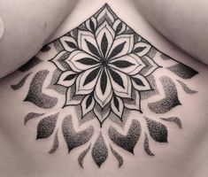 a woman's stomach with a tattoo design on it