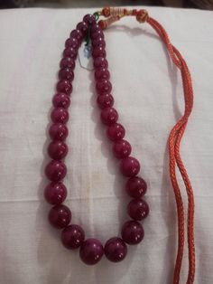 Ruby Necklace Natural Ruby Corundum Smooth Round Beads 513 Carat AAA Ruby Necklace With Adjustable Code Necklace 1.Ruby Corundum 2. Ruby Round Beads 3. 14 inches length, 1 Line String 4. 513 -carat weight 5. 10x10 - 12x12 mm stone size 6, The necklace is with tassel because you can easily adjust your necklace length. 7. If you want any changes in the necklace example if you want with clasp we can do it. Polish :- Handmade Purity :- AAA These natural Ruby gemstones can be used to make different j Beaded Round Temple Jewelry Necklaces, Beaded Temple Jewelry Round Necklace, Temple Jewelry Necklaces With Polished Beads, Handmade Temple Jewelry Pearl Necklace With Round Beads, Formal Round Beaded Necklace With Large Beads, Formal Beaded Necklaces With Large Round Beads, Formal Round Beaded Necklaces With Large Beads, Handmade Temple Jewelry Beaded Necklace, Formal Beaded Necklaces With Large Beads