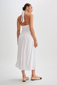 Summer ready.Introducing the HARRIETTE Halter Midi Dress, a captivating ensemble that exudes timeless elegance. With its V neckline and functional halter, this dress offers a chic and sophisticated silhouette. The fitted waist accentuates your figure with grace, while the gathered skirt adds a touch of femininity and movement. Designed in a midi length, it strikes the perfect balance between sophistication and allure. Lined for comfort and coverage, the Harriette is perfect for any occasion wher Fitted Halter Neck Lined Maxi Dress, Halter Neck Dress With Gathered Neckline For Date Night, Formal Sleeveless Midi Dress With Gathered Neckline, Fitted Sleeveless Halter Dress With Gathered Neckline, Evening Midi Dress With Fitted Bodice And Halter Neck, Fitted Halter Dress With Gathered Neckline, Chic Fitted Backless Dress With Smocked Back, Chic Halter Dress With Ruched Bodice For Evening, Formal Halter Neck Midi Dress With Fitted Bodice