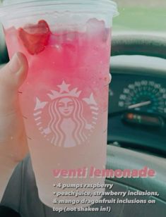 a person holding up a pink drink with strawberries in it's cup and the words, venti lemonade