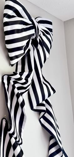 black and white striped bow hanging on the wall