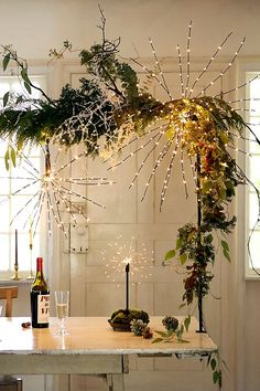 the table is decorated with greenery and lights