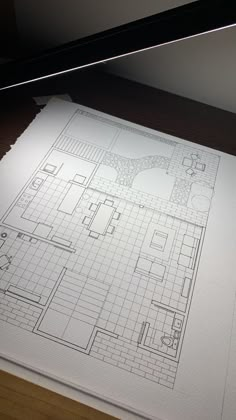 a drawing of a floor plan on top of a piece of paper with a pen in it