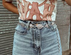 Simple silver belts are all the rage this season! Which means adding our Silver Concho Belt to your closet is a must. Wear with your favorite denim to make a statement all while showing off your western flair!   S/M is 42in end to end, but you can adjust the last 7-8in (Pendant 16pcs) L/XL is 45.5in end to end, but you can adjust the last 7-8in (Pendant 18pcs)  Model is wearing S/M. Silver Western Belt, Conch Belt Outfit Western, Concho Belt Outfit, Western Belts Outfit, Country Belts, Belt Outfit, Cowgirl Aesthetic, Rodeo Outfits, Cowgirl Chic