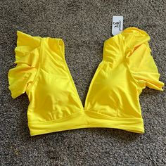 - Pads - Ruffle Shoulders Fitted Ruffle Tops For Poolside, Ruffled Tops For Pool And Summer, Summer Ruffled Tops For Pool, Fitted Ruffle Tops For Beach Season, Ruffled Tops For Summer Pool Parties, Yellow Ruffled Top For Beach, Beach Season Tops With Ruffles, Yellow Tops For Beach Season Parties, Fitted V-neck Tops For Beach Party