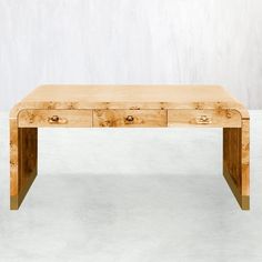 a wooden table with two drawers sitting on top of white carpeted floor next to wall