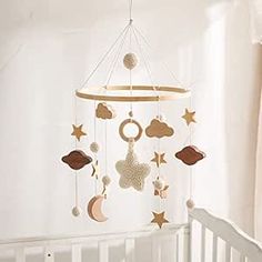 a baby crib with a mobile hanging from the ceiling