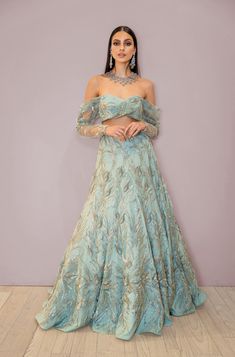 Step into luxury with our SUNITA Mint Sage Green Bridal Lehenga Set. This stunning lehenga set features a regal sage green color, trending for 2024 brides. Perfect for the Indian bride, this lehenga set exudes sophistication and grace. Stun in this off-the-shoulder top and high waist lehenga skirt for an unforgettable walk down the aisle. Embroidered with silver and gold accents in both sequins and glass beads that cascade down the skirt and throughout the blouse. This set includes the SUNITA To Green Bridal Lehenga, Lehenga Skirt, Modern Bridal, Walking Down The Aisle, Bridal Lehenga, Indian Bride, Sage Green, Off The Shoulder, Lehenga