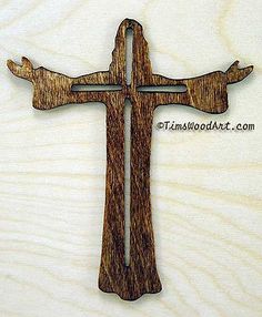 a wooden cross with two birds on it