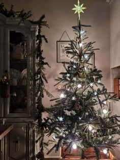 a small christmas tree is lit up in the living room